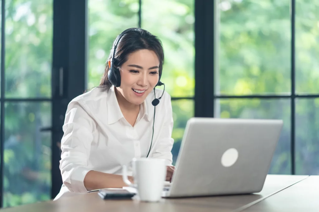 asian-telemarketing-or-call-center-with-headset-working-on-laptop